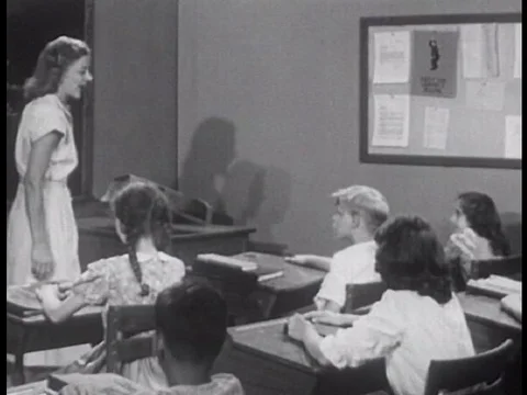 An American elementary school teacher helps moderate her children's choice for Video stock 74975788