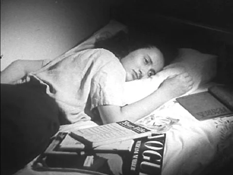 An American elementary school teacher helps moderate her children's choice for Video stock 75008933