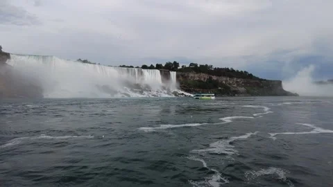 American Falls and the Niagara Falls Observation Tower seen from water level Stock Footage 345996053