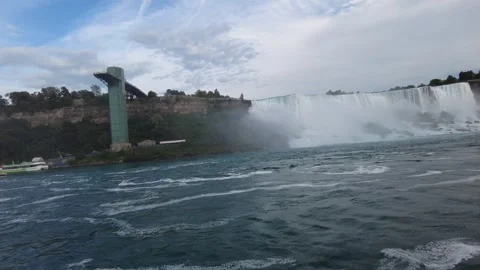 American Falls and the Observation Tower with tour boats at the base Stock Footage 345996067
