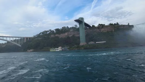 American Falls, the Niagara Falls Observation Tower and the Rainbow Bridge Stock Footage 345996064