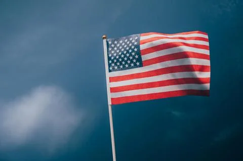 American flag, on against a overcast sky. Stock Photos
