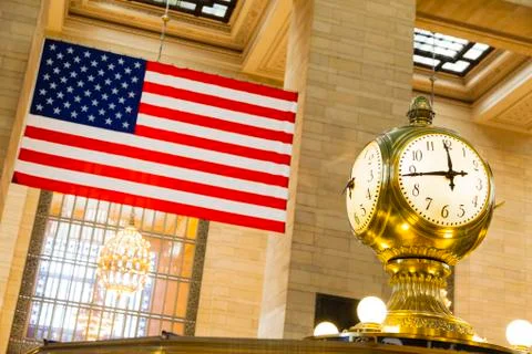American flag and old clock at grand central station in new york Stock Photos