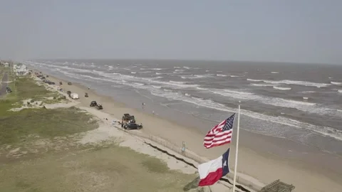 American Flag and Texas Flag fly over Crystal Beach Stock Footage 202187587