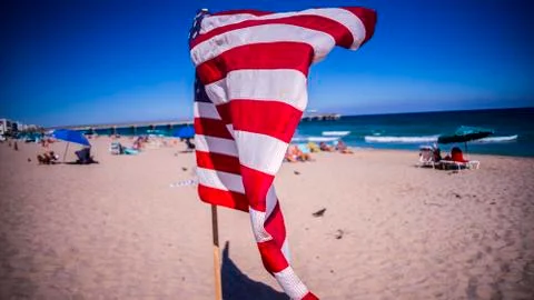 American flag on the beach in wind Stock Photos