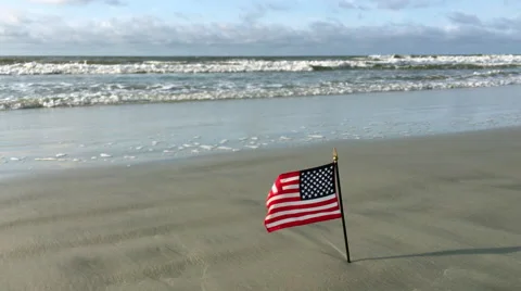 American flag blowing at beach Stock Footage 65051399