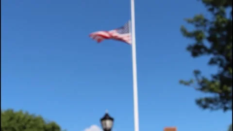 American flag blowing in the wind, in and out of focus Stock Footage 304367760