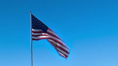 American Flag Blowing in the Wind in Blue Skies Timelapse Stock Footage 202196000