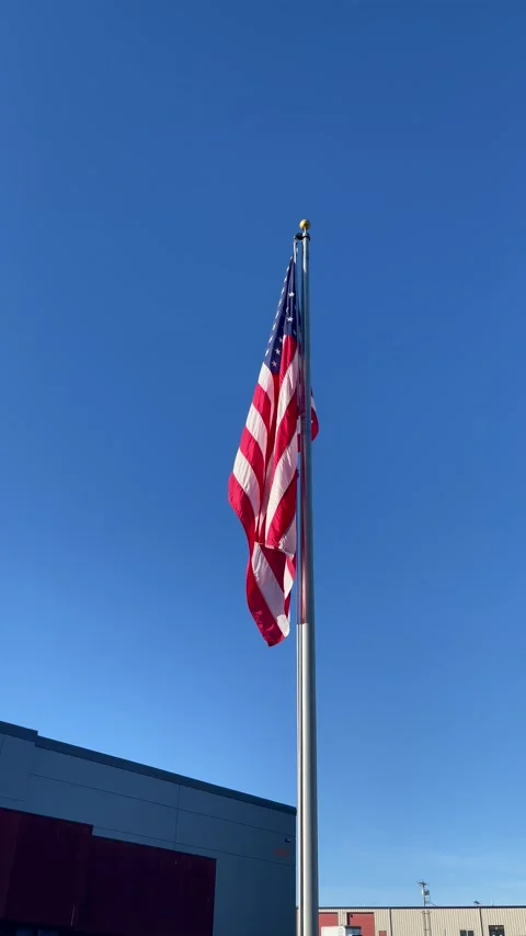 American flag blowing in the wind on the blue sky background Stock Footage 209632666