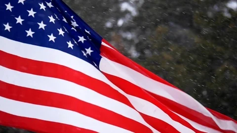 American flag blowing in wind during winter snow storm. Stock Footage 108014534