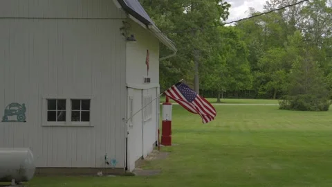 American flag blowing in the wind on midwest building Stock Footage 277640904