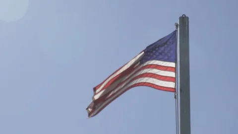 American flag blows in the wind backflip by the sun￼ Stock Footage 121327486