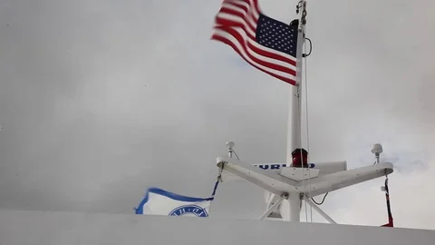American flag blows in the wind on a boat Stock Footage 124386557