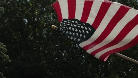 American Flag Blows In The Wind Towards The Lens In Slow Motion Vídeos de archivo 156353382