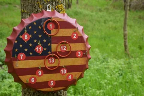 American Flag Bottle Cap Ring Toss Game Board Hanging on Tree Outdoors Фото