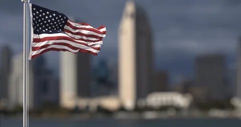 American Flag  with city scape on the background Stock Footage 126556573