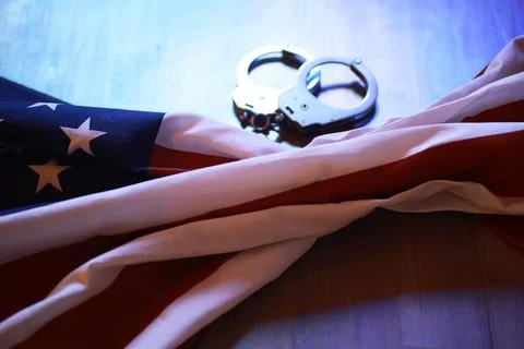 American Flag Draped with Handcuffs Representing Freedom and Justice Stock Photos