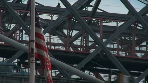 American flag on flag pole with Williamsburg Bridge in background, day. Stock-Footage 110919208