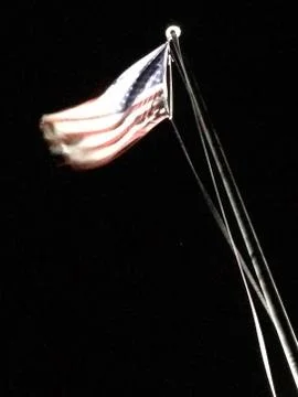 American flag on flagpole motion background black Stock Photos