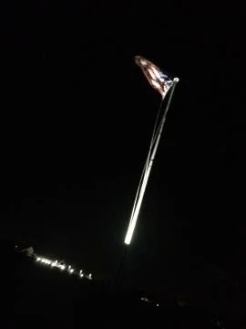 American flag on flagpole motion background at night Stock Photos