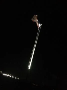 American flag on flagpole motion background at night Stock Photos