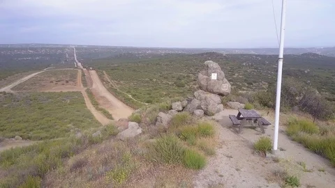 The American flag flies over the U.S. Mexico border in the California desert. Stock Footage 79400164