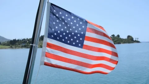 American flag fluttering in the wind on a sailing yacht sailing on the blue sea Stock Footage 111707848