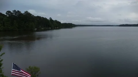 American flag fly by on a lake Stock Footage 239938835