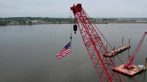 An American Flag flying from a crane 스톡 동영상 241364778