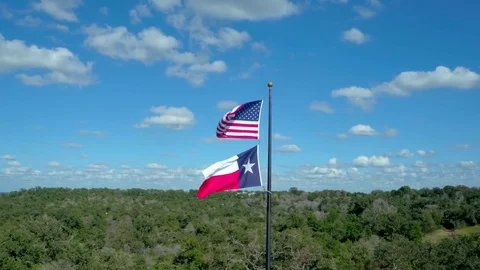 American Flag Flying Over the Texas Flag by Aerial Drone Vídeos de archivo