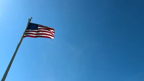 American flag flying in the wind with copy space to the right Stock Footage 331298989