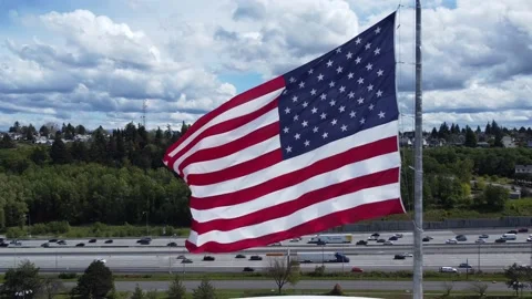 American Flag Flying in the Wind in Front of Interstate Stock Footage 194562768