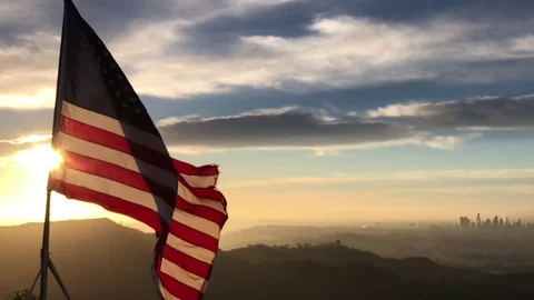 American flag flying in the wind at sunrise Slow Motion Stock Footage