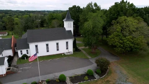 American flag flys outside small church in farmington nc, north carolina Stock-Footage 163262795