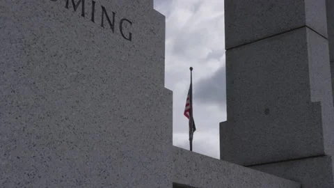 American Flag Framed by by Stone Monument in Washington D.C. on Overcast Day Stock Footage 211869463