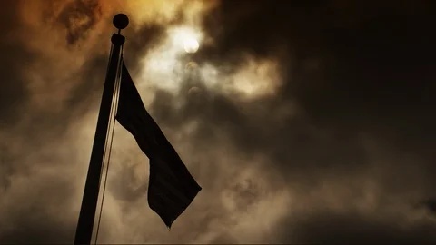 American Flag in Front of a Cloudy Sky and Sun HD Video Stock Footage 92087087