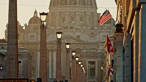 American flag in front of St. Peter's Basilica in Vatican City at sunset Stock Footage 308409020