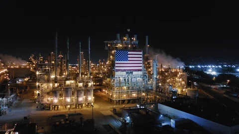 American flag in front of the view of large petroleum refinery working at night Video stock 129655684