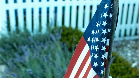 American Flag In Front Of A White Picket Fence House Stock Footage