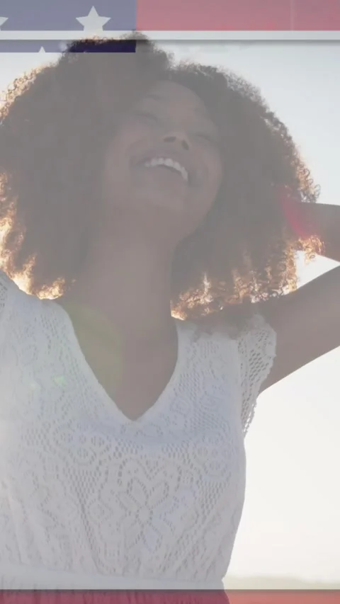 American flag with glitch effect against african american woman smiling at the Stock Footage 341658216