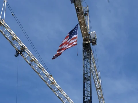 American Flag Hanging from Construction Crane Waving Stock Footage 81884878