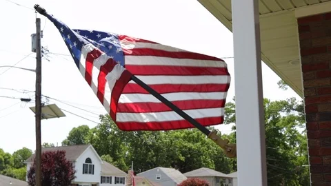 American flag hanging from the front of house 動画素材 111400560