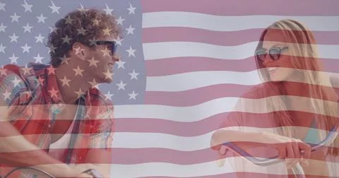 American flag image over smiling couple riding bicycles Ilustração Stock