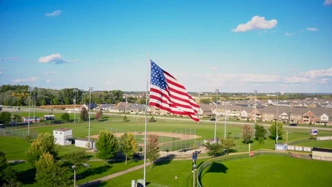 American Flag Over Baseball Diamond 2 Stock Footage