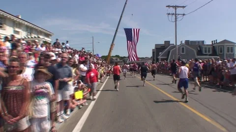 American Flag pan down to runners finishing race Video stock 171778590