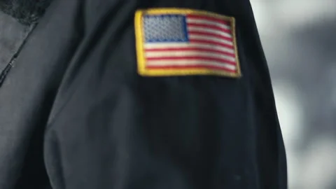American flag patch on the arm of a security contractor uniform Stock Footage 133546487