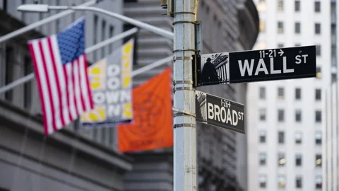 American Flag Rack Focus to Wall Street Sign Video stock 246928415