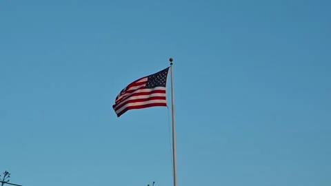 American flag with red and white stripes and blue stars, waving gracefully Stock Footage 294553708
