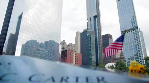 American Flag Reflected in Memorial Pool with Majestic City Skyline Stock Footage 274166516