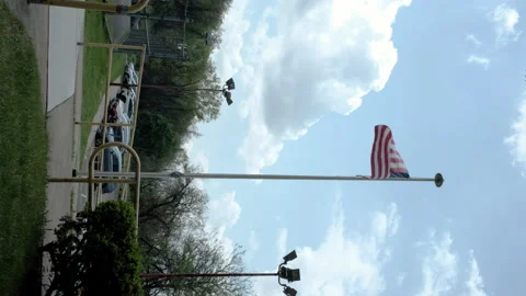 American flag seen flying high on a flagpole Stock Footage 274907823
